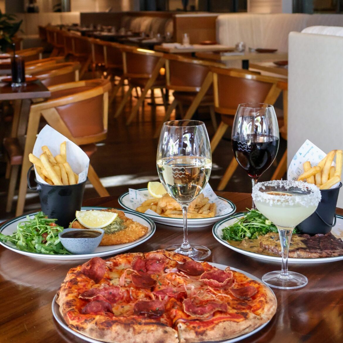 Freshly baked wood-fired Carnivore pizza with premium meats at CORA Restaurant Gold Coast.