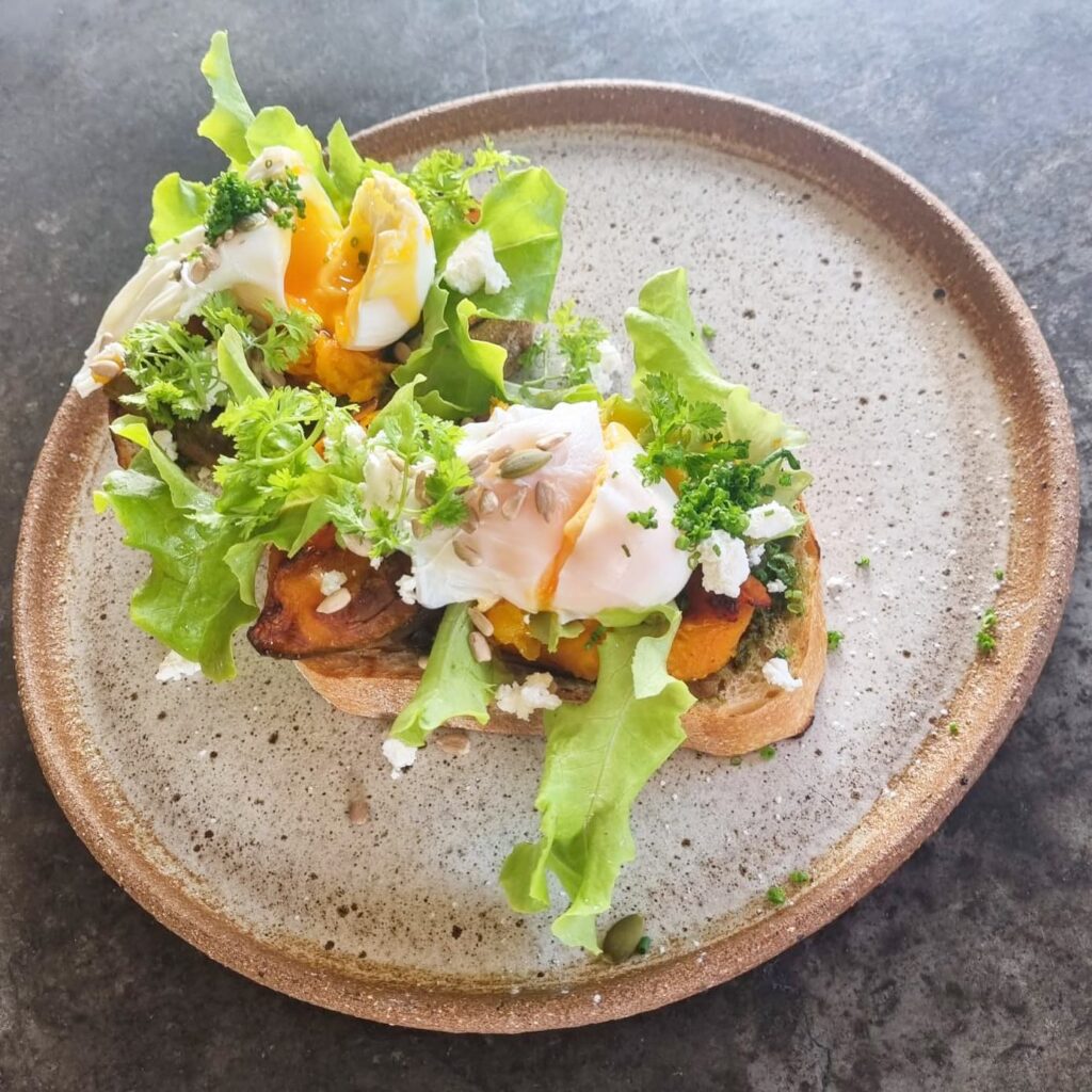 Beautifully presented eggs on toast with fresh garnish at Sanctum Kitchen & Bar Harbourtown Gold Coast