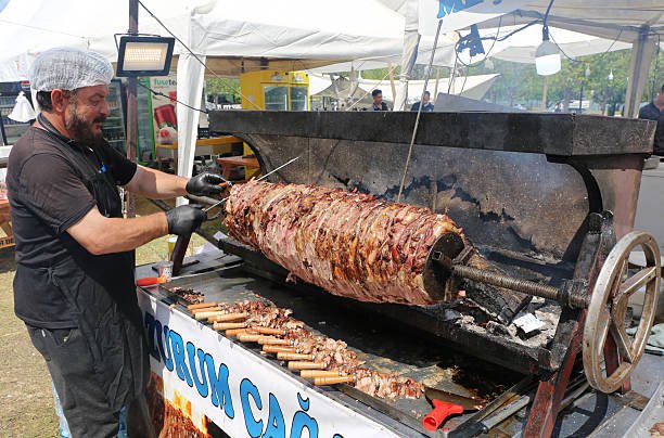 Chef grilling meat over hot coals at the Gold Coast Greek Festival in Surfers Paradise